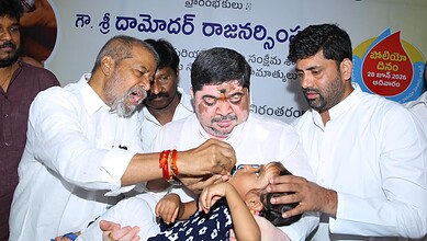 Officials administering polio drops to a child during a vaccination campaign in Telangana.