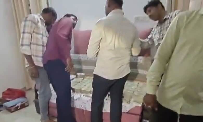 Officials inspecting documents during Telangana ACB raid at Land Survey dept locations.
