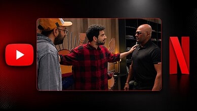 Three men having a discussion in a room with a Netflix logo in the background.