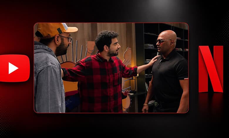 Three men having a discussion in a room with a Netflix logo in the background.