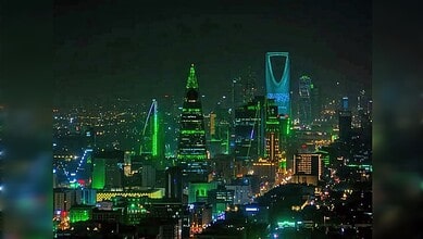 Riyadh skyline illuminated at night with prominent skyscrapers in Saudi Arabia.