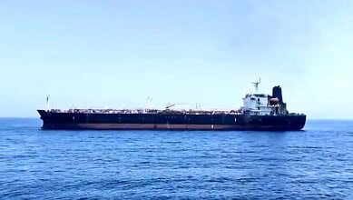 Oil tanker ship sailing on calm sea under clear sky, maritime transportation, shipping industry, large ve.