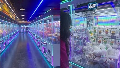 Claw machine arcade with colourful neon lighting and plush toys inside, vibrant gaming environment.