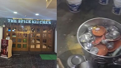The Spice Kitchen restaurant entrance with a sign and a green mat outside.