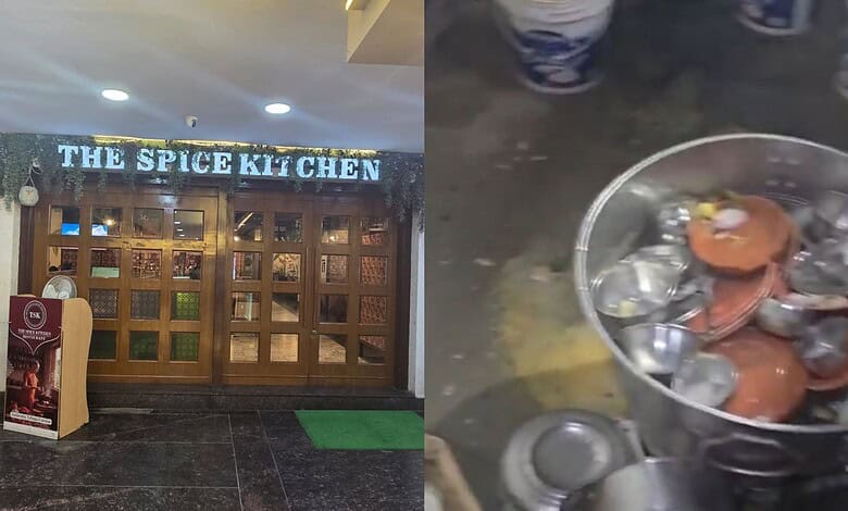 The Spice Kitchen restaurant entrance with a sign and a green mat outside.