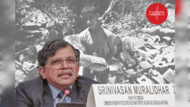 Srinivasan Muralidhar, chief of the UN Independent International Commission of Inquiry, speaks at a UN event, with an image of a Palestinian child standing amid rubble in Gaza in the background.