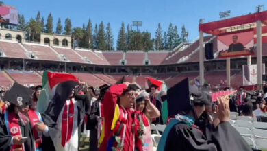 Stanford graduates carrying Palestinian flags walk out during Google CEO Sundar Pichai's commencement speech.