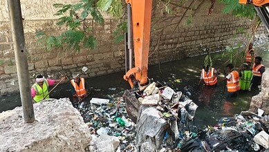 GHMC workers clean up trash from Darussalam nala