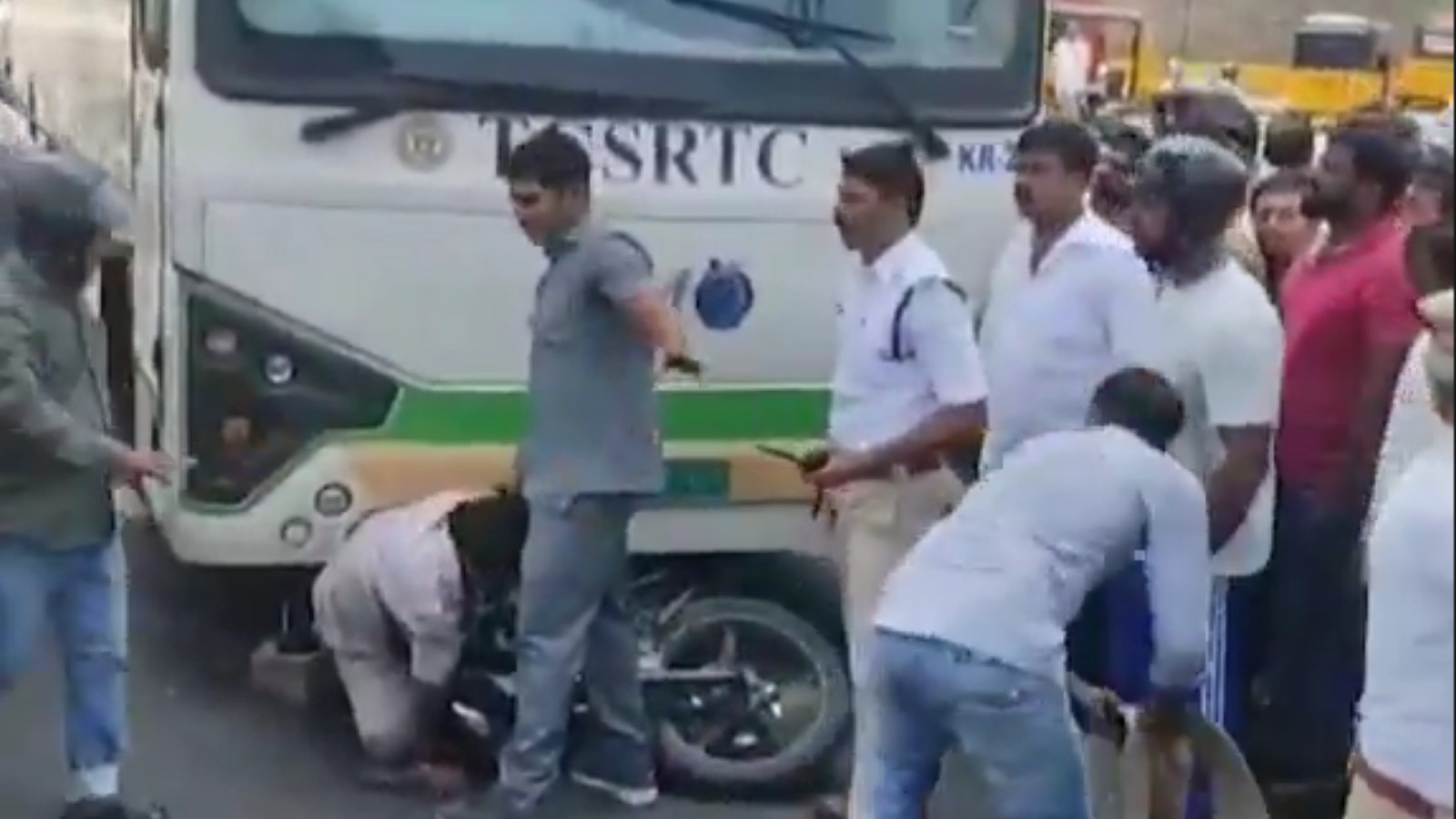 two-wheeler rider stuck underneath RTC bus after accident