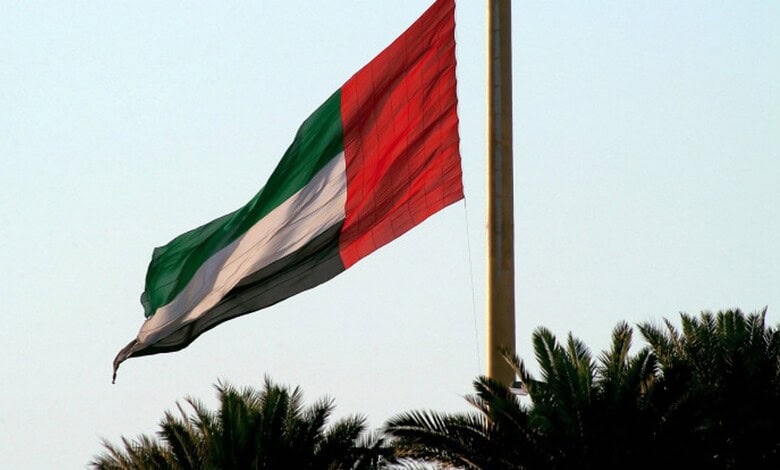 Flag of the United Arab Emirates waving in the wind, with green, white, black, and red colours.