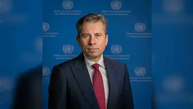 UN relief chief in front of UN backdrop, calling for lifting Gaza aid restrictions.