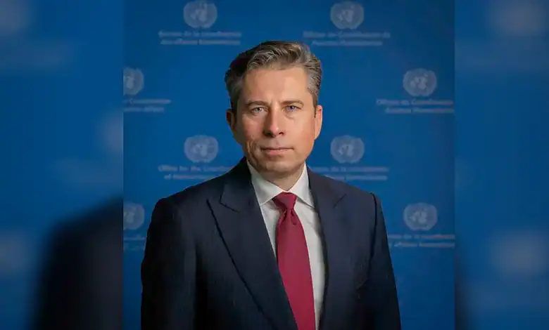 UN relief chief in front of UN backdrop, calling for lifting Gaza aid restrictions.