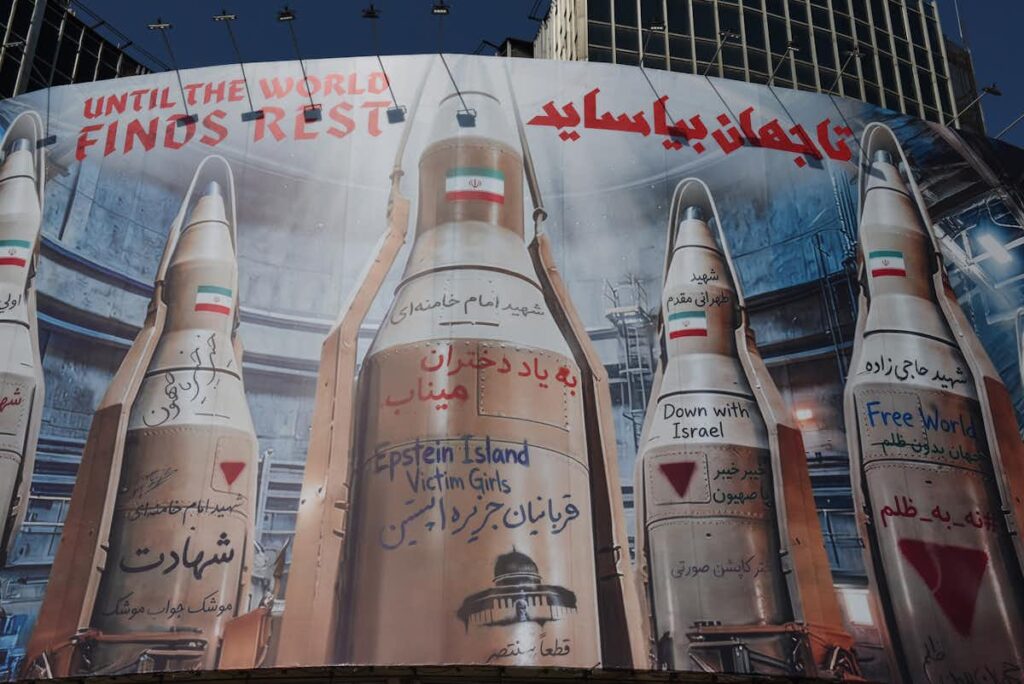 Billboard in Valiasr Square showing Iranian missiles covered with handwritten messages and slogans during the Iran-US-Israel conflict, March 17, 2026.