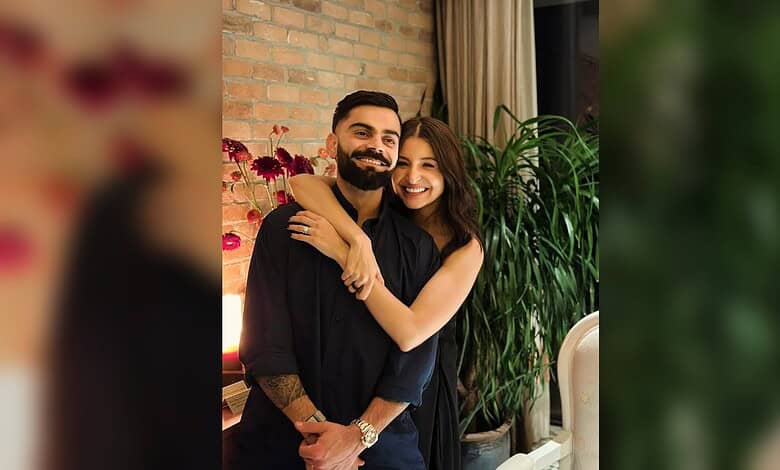 Virat Kohli and Anushka Sharma smiling and embracing each other indoors.