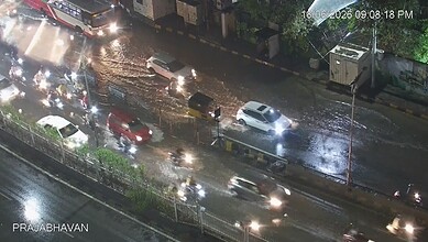 Heavy traffic and waterlogged roads in Hyderabad due to moderate rain, causing traffic delays.