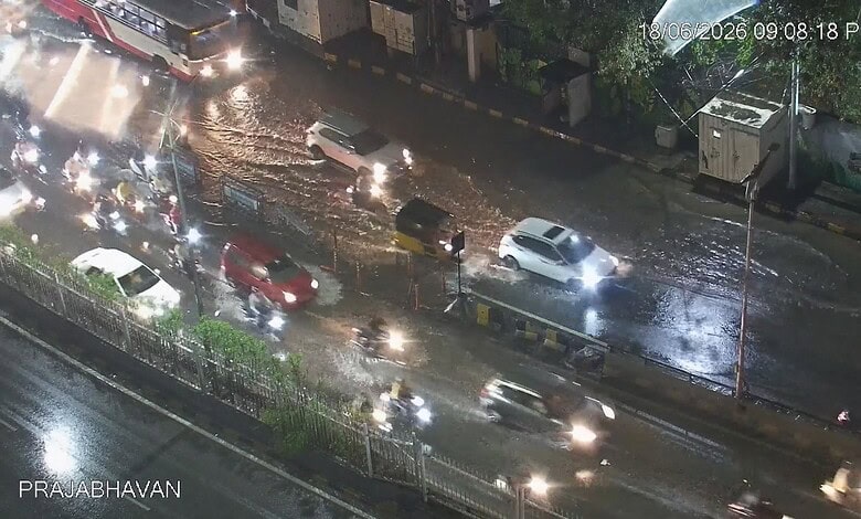 Heavy traffic and waterlogged roads in Hyderabad due to moderate rain, causing traffic delays.