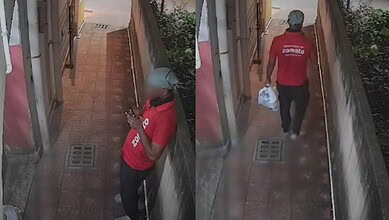 Zomato rider in red uniform leaving after marking order delivered, captured on CCTV footage.