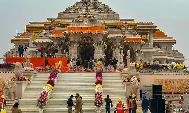 Construction of Ram Mandir with workers and visitors present at the site.