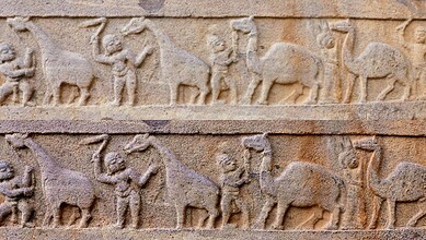 The image shows a panel at Srisailam temple which depicts camels and giraffes with their attendants.