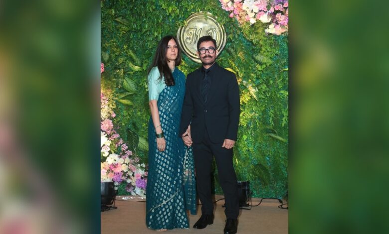 Aamir Khan and Gauri Khan at their wedding celebration, standing in front of a floral backdrop.