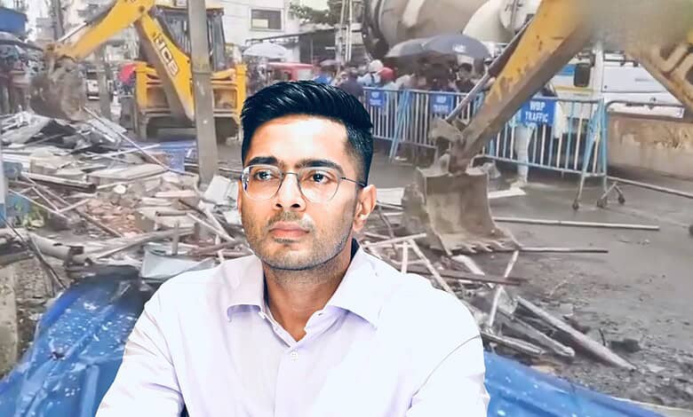 Man in white shirt and glasses at demolition site with bulldozers in background.