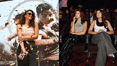 Two women seated at a cinema, one with glasses and the other with long hair, watching a film.