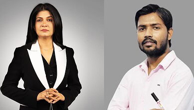Professional portrait of a woman and a man against a grey background.