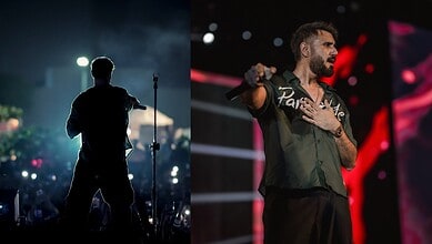 Mustafa Zahid singing passionately during a concert, with stage lights and audience in the background.
