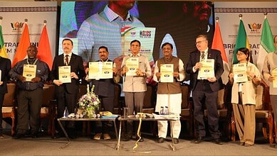 Group of officials and leaders holding certificates at a formal event in India.