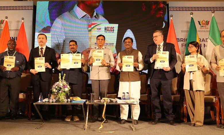 Group of officials and leaders holding certificates at a formal event in India.
