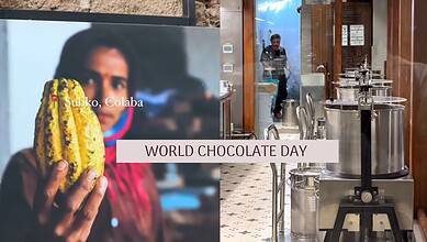 Woman holding a large chocolate-filled pastry at a chocolate factory for World Chocolate Day.