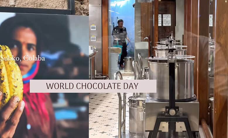 Woman holding a large chocolate-filled pastry at a chocolate factory for World Chocolate Day.
