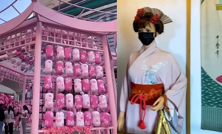 Display of pink Japanese-themed lanterns and a woman in traditional kimono at an event.
