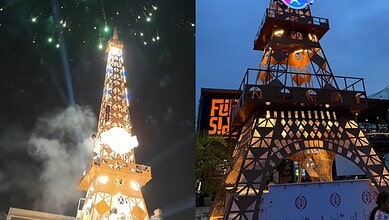 Illuminated replica of the Eiffel Tower in Hyderabad during night with fireworks.