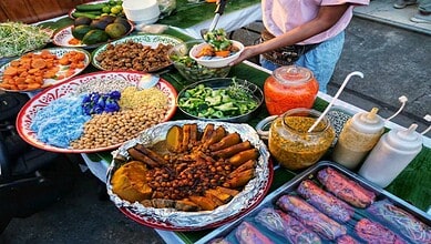 Vibrant street food display with various dishes and condiments at Chaurah Auditorium.