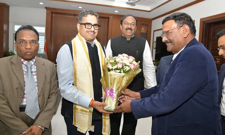 Group of men in formal attire exchanging a bouquet in an office setting.