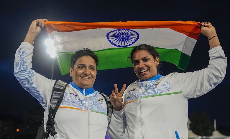 Two Indian para athletes holding the Indian flag after winning gold at the Commonwealth Games.