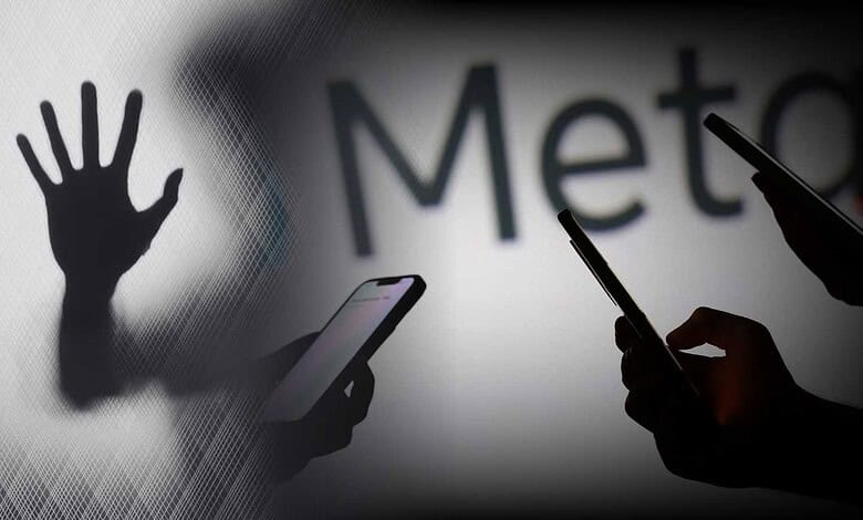 Silhouettes of hands and smartphones against a blurred background with 'Meta' text.
