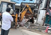 Construction machinery demolishing encroached structures on Hyderabad's DLF food street.