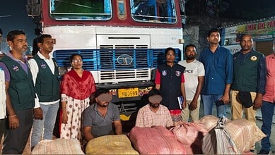 Police and officials with seized ganja bags in front of a truck on the highway.