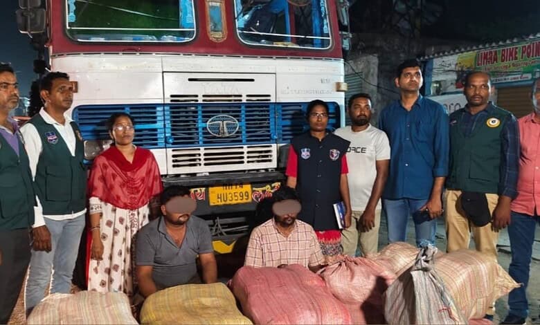 Police and officials with seized ganja bags in front of a truck on the highway.