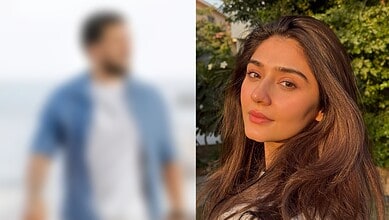 Portrait of a young woman with long brown hair outdoors in sunlight.