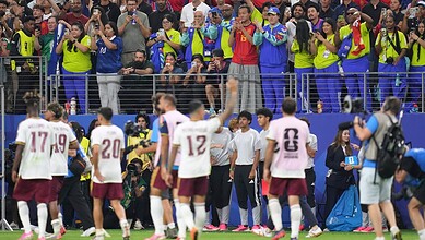 Celebrating football players and fans after a match at the FIFA World Cup.