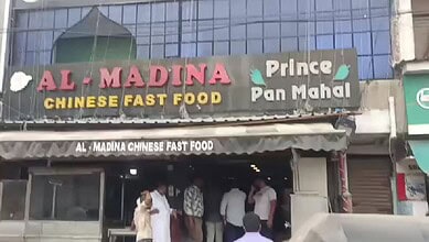 Al Madina Chinese Fast Food restaurant exterior with customers inside in Hyderabad.
