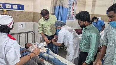The image shows a tribal student being treated at Achampet Government Hospital, after falling ill due to food poisoning at Mannanur PVTG Boys' Gurukul hostel on Thursday, morning, July 9, 2026.