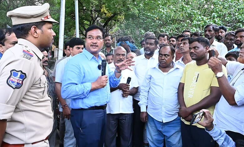 Community meeting with police officer and residents in Hyderabad, discussing housing issues.