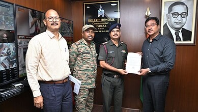 Commissioner HYDRAA receiving a document from a man in a black shirt in Hyderabad.