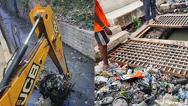 Excavator removing silt from Hyderabad nala during cleanup operation.