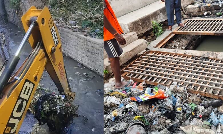 Excavator removing silt from Hyderabad nala during cleanup operation.