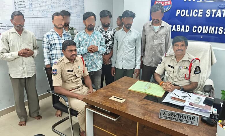 Police officers and suspects in Hyderabad gambling den bust, Attapur, Telangana.